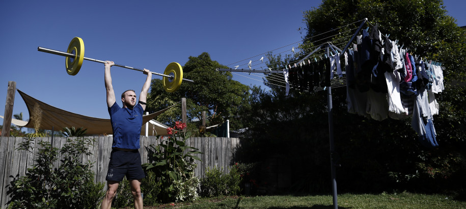 Matt Wilson lifts weights in his backyard