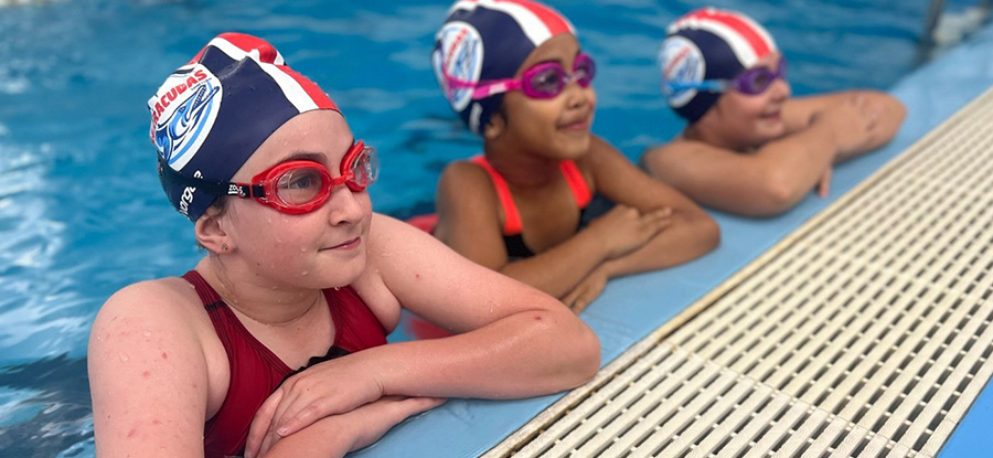 Coulter Barracudas swimmers on pool ledge