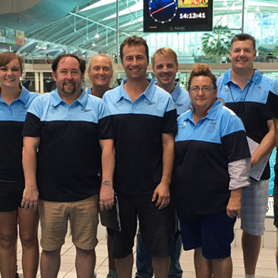 Group picture of male and female NSW coaches at a pool