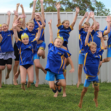 Swim Club members jumping in the air