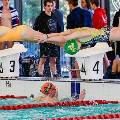 Female swimmers during relay change over in Swim League competition