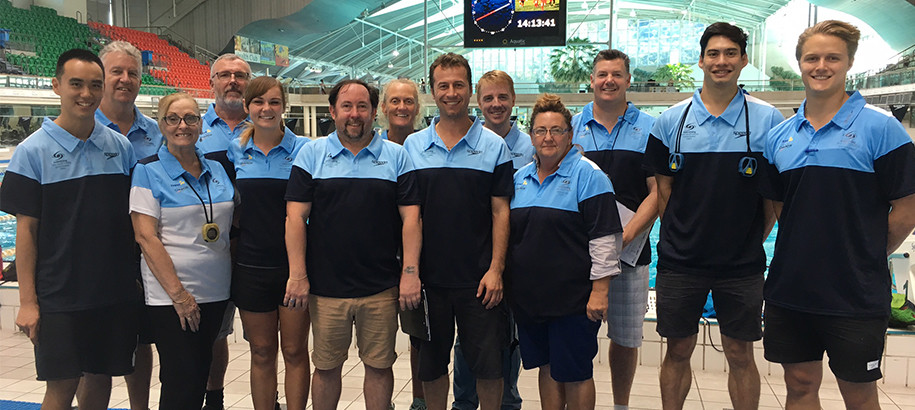 Group picture of male and female NSW coaches at a pool