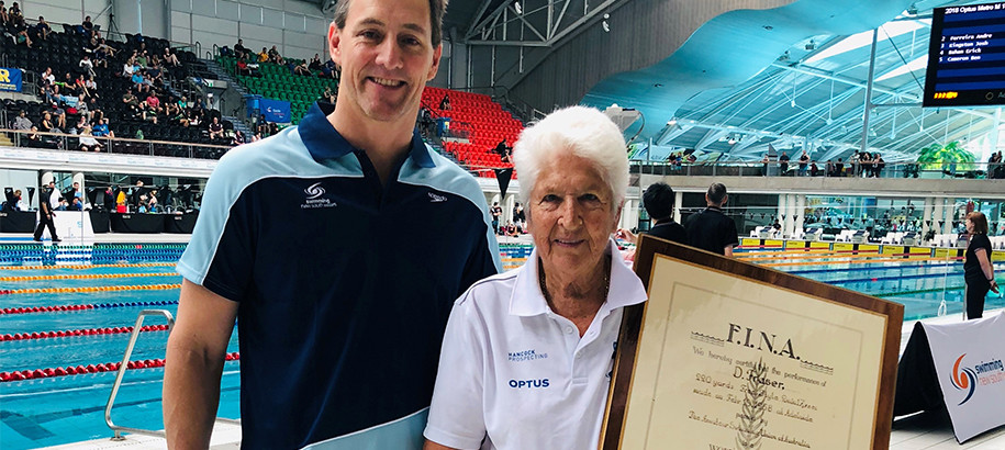 Dawn Fraser OAM is awarded two World Record Certificates by Chris Fydler OAM