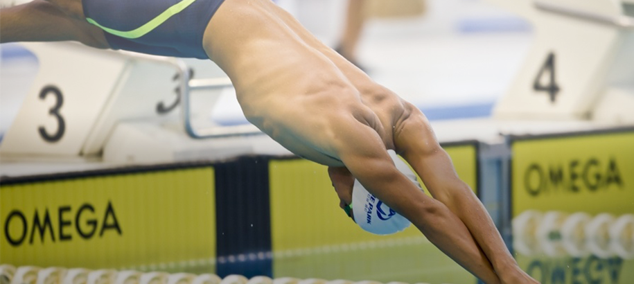 Swimmer diving into pool