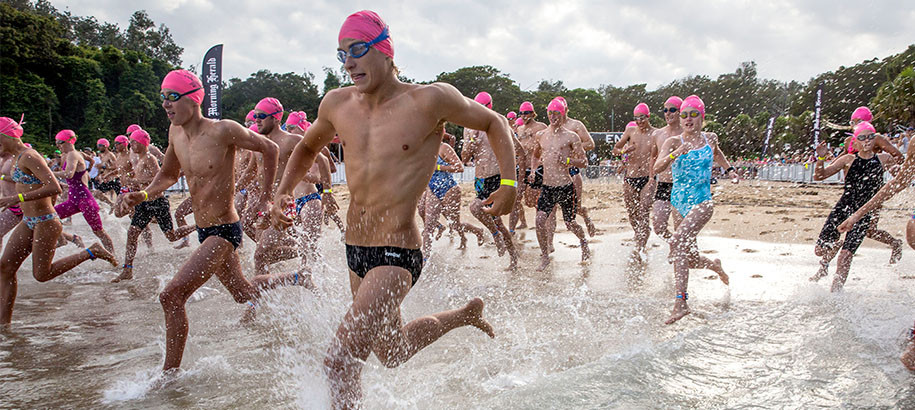 Open Water Swimmers running into the ocean