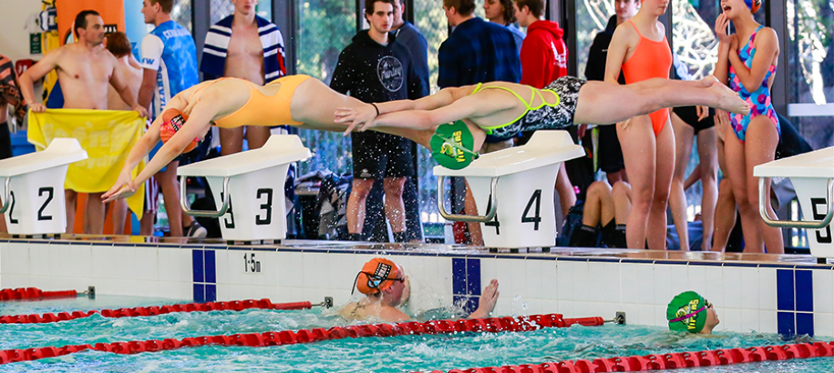 Female swimmers during relay change over in Swim League competition